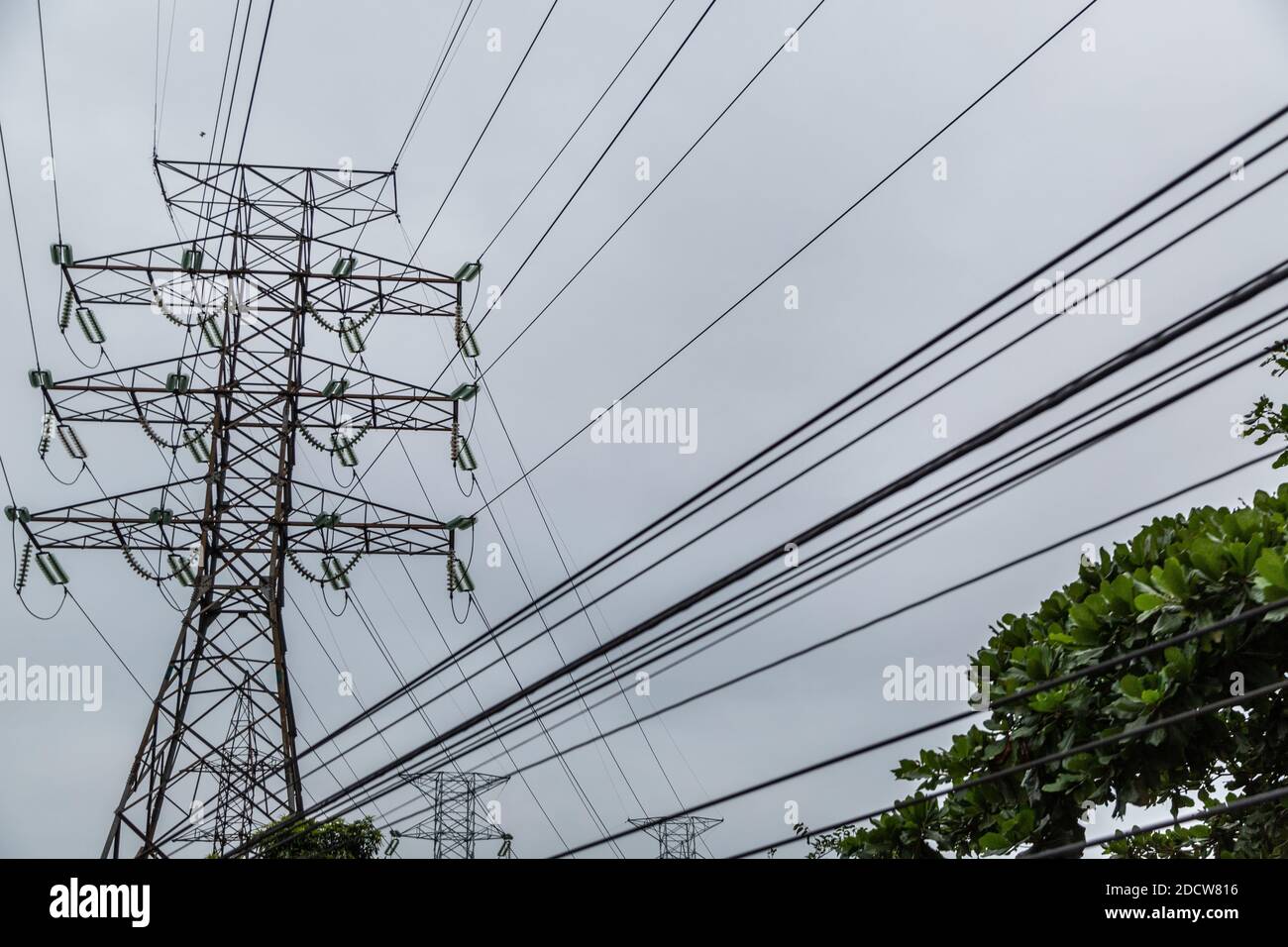 A low angle shot of the power lines captured on a cloudy day - concept ...