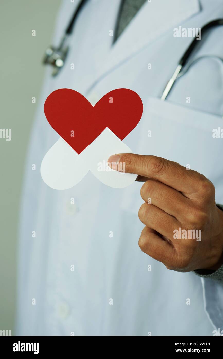 closeup of a doctor man, in a white coat, showing an antibiotic resistance symbol in his hand Stock Photo