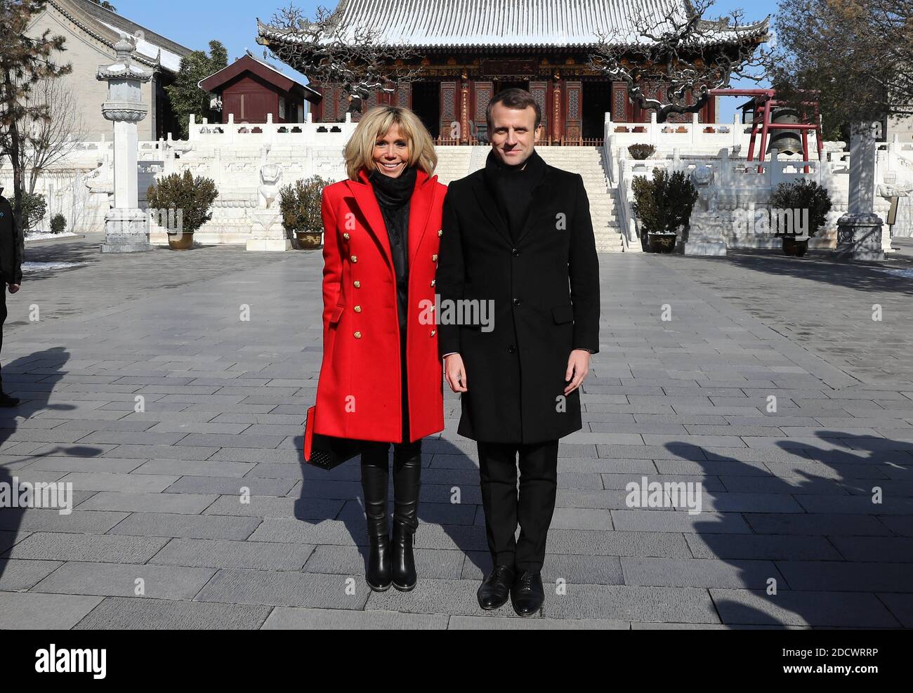 French President Emmanuel Macron and his wife Brigitte Macron listen to