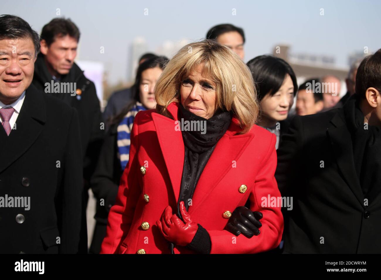 French President Emmanuel Macron and his wife Brigitte Macron listen to