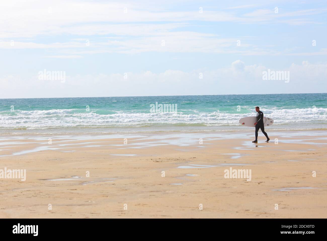 Surfer with surfboard walking at Fistral Beach Newquay , Cornwall, England Stock Photo