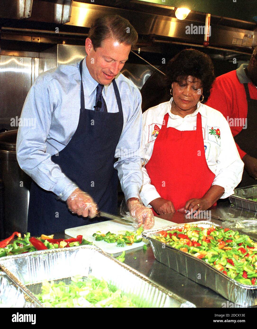 United States Vice President Al Gore prepares sandwiches at Martha's Table, a shelter that provides meals to the homeless in Washington, D.C. on 15 October, 1999. Olivia Ivy, Director of Operations at Martha's Table, looks on.Credit: Ron Sachs / CNP/ABACAPRESS.COM Stock Photo