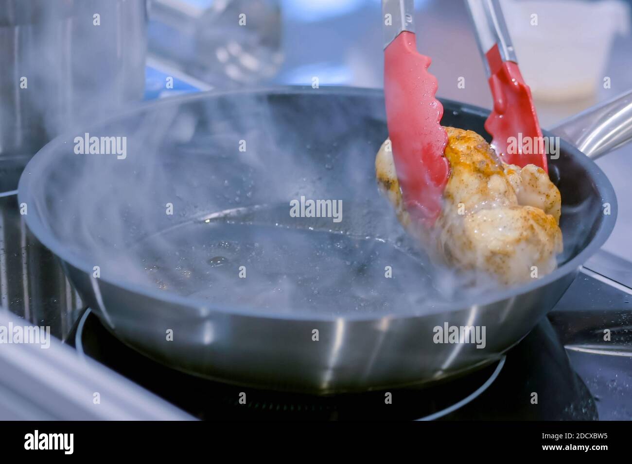 Chicken frying in pan Stock Photo Alamy