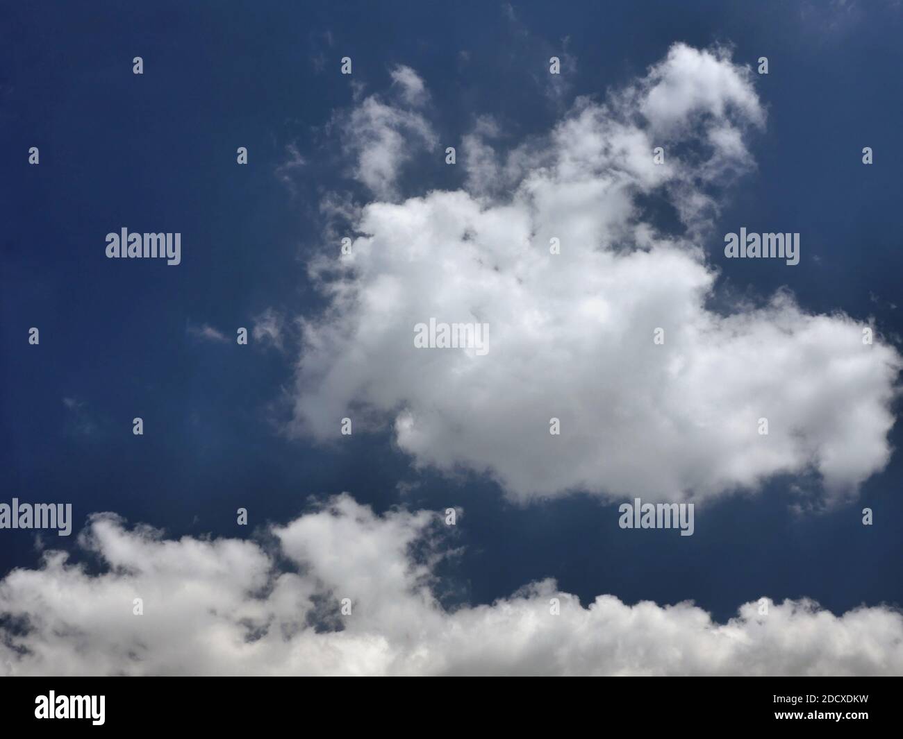 white fluffy clouds on blue sky in summer Stock Photo - Alamy