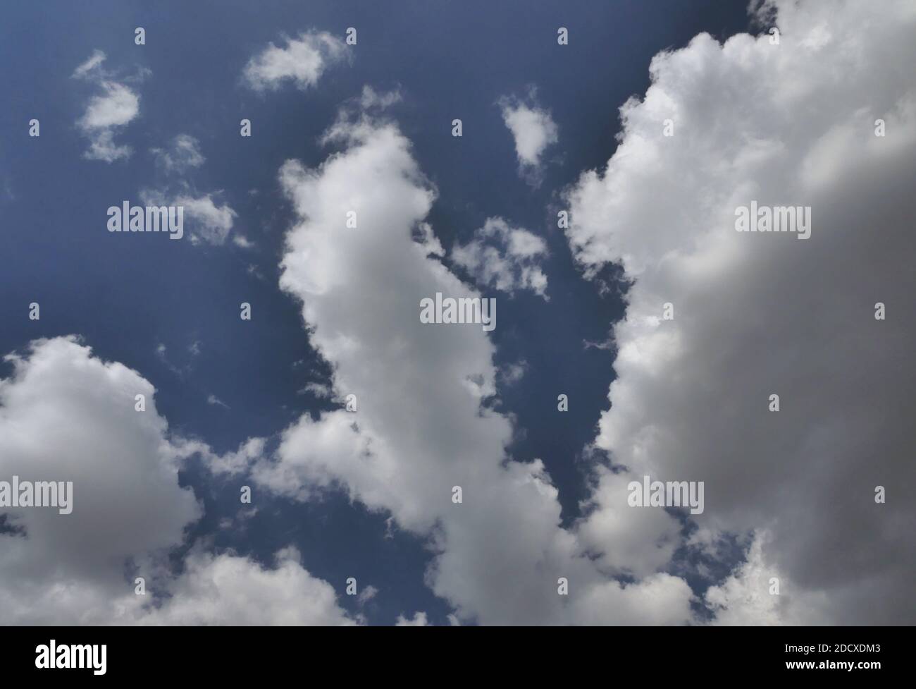 White fluffy clouds on blue hi-res stock photography and images - Alamy