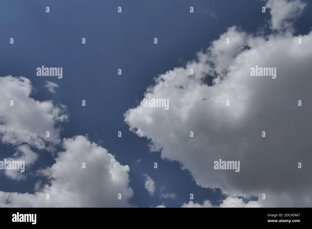 White fluffy clouds on blue hi-res stock photography and images - Alamy
