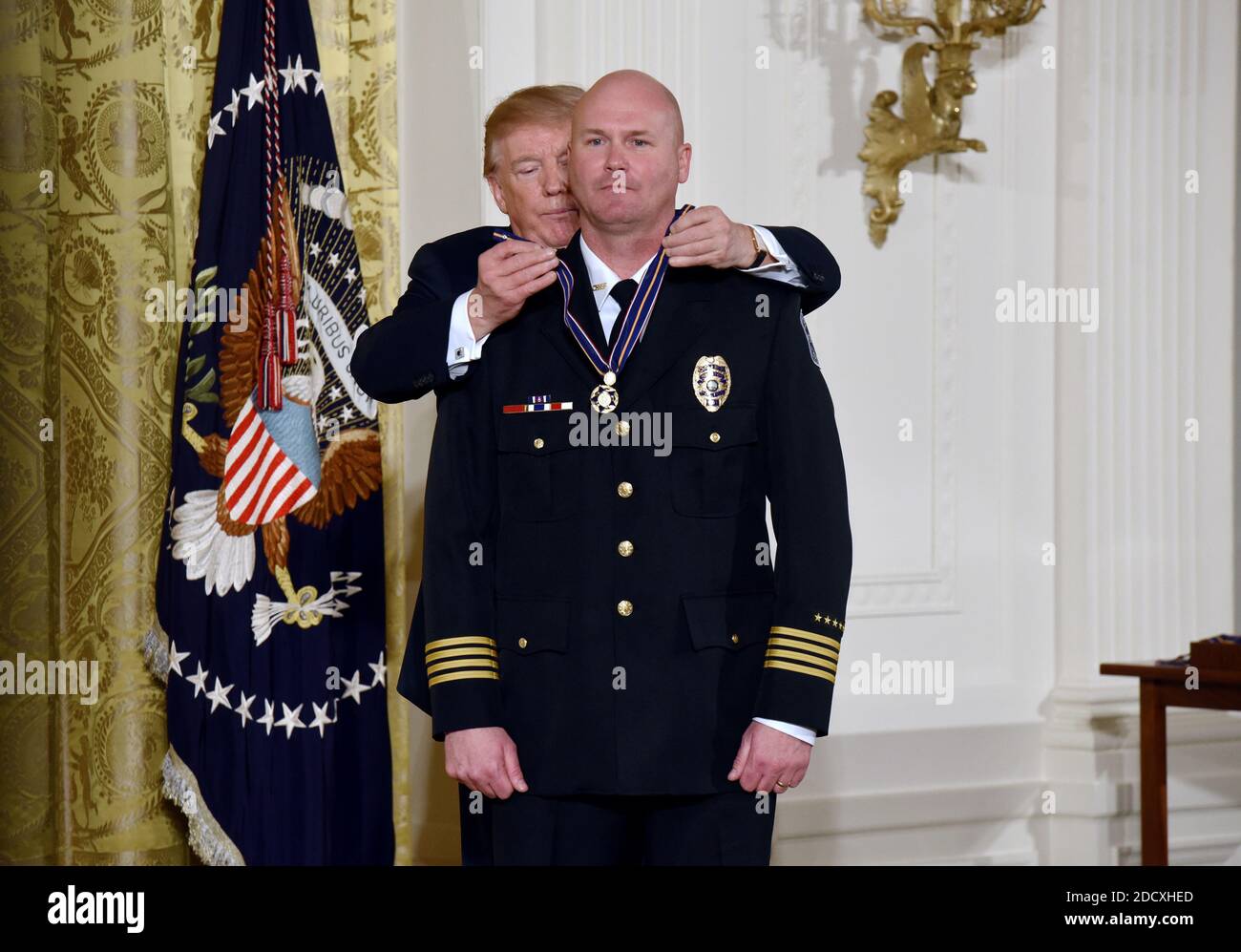U.S. President Donald Trump (L) presents the Public Safety Medal of