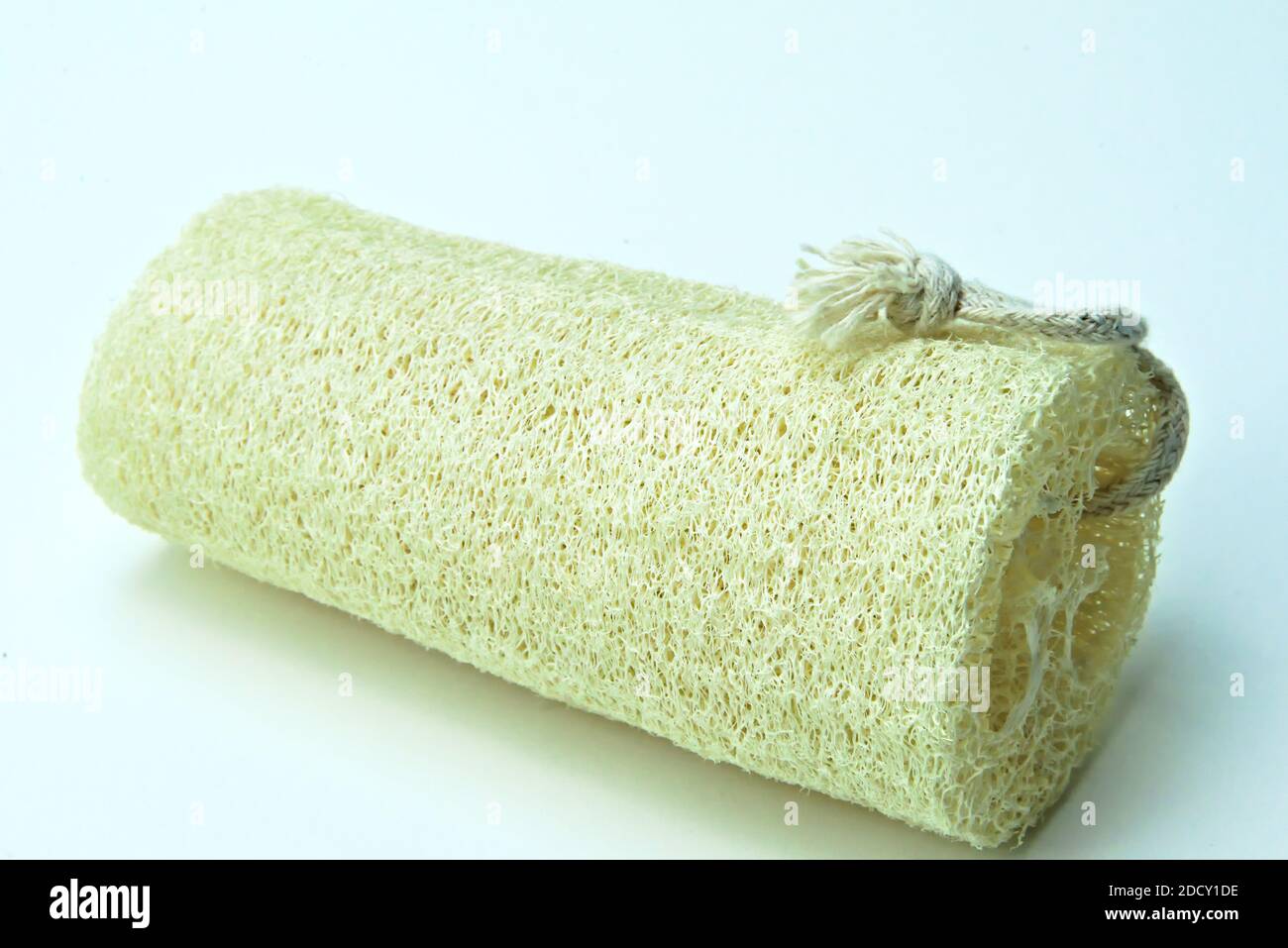 Natural bathing sponge for scrubbing dead skin cells. Isolated on white Stock Photo