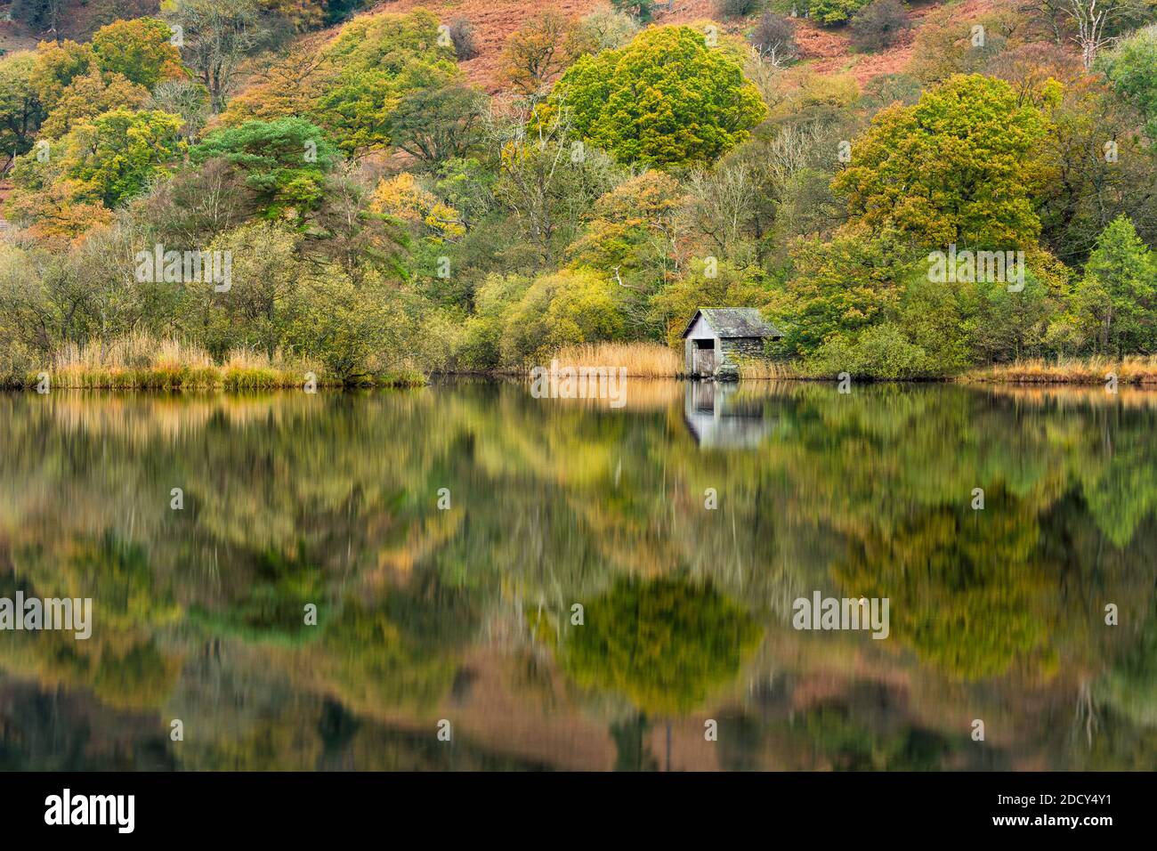 Boathouse at Rydal Water in the Lake District with Autumn colours and reflections. Stock Photo