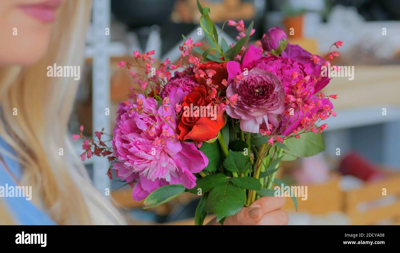 Professional florist making beautiful bouquet at flower store Stock Photo