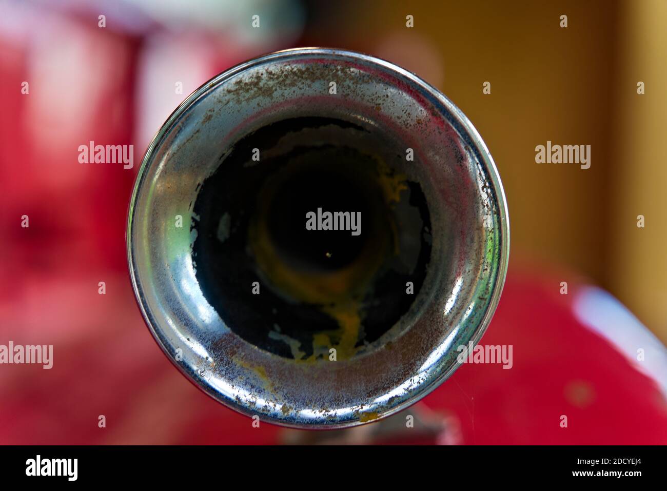 Chrome air horn on a red firetruck seen from the front. Stock Photo