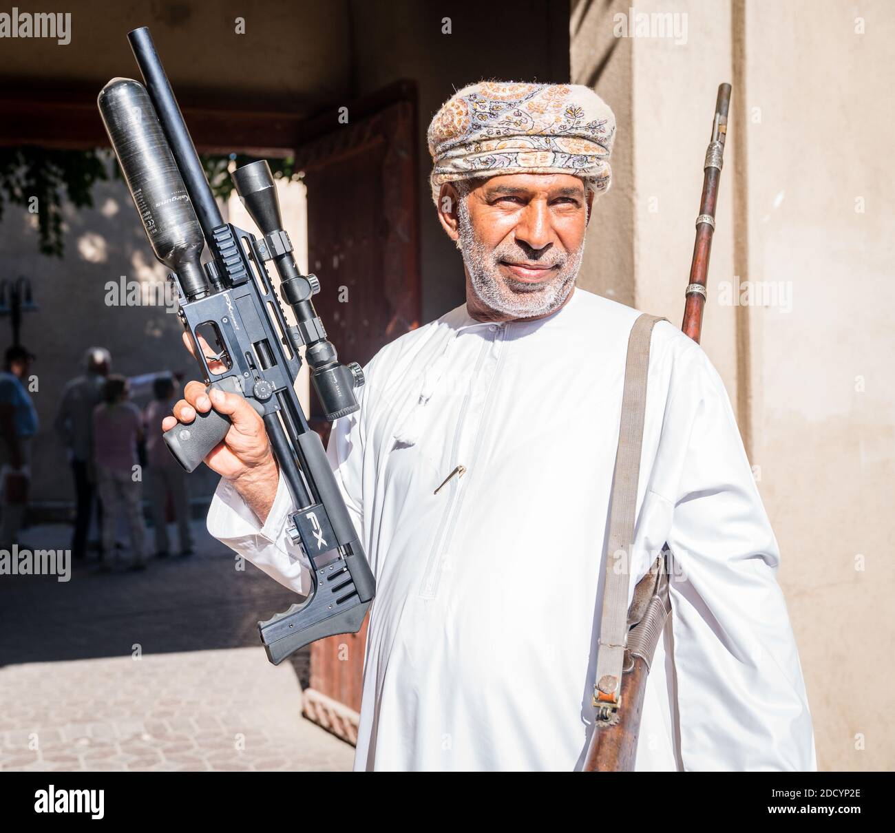 Nizwa, Oman, December 2, 2016: A man is displaying an air gun at the Friday gun market in Nizwa, Oman Stock Photo