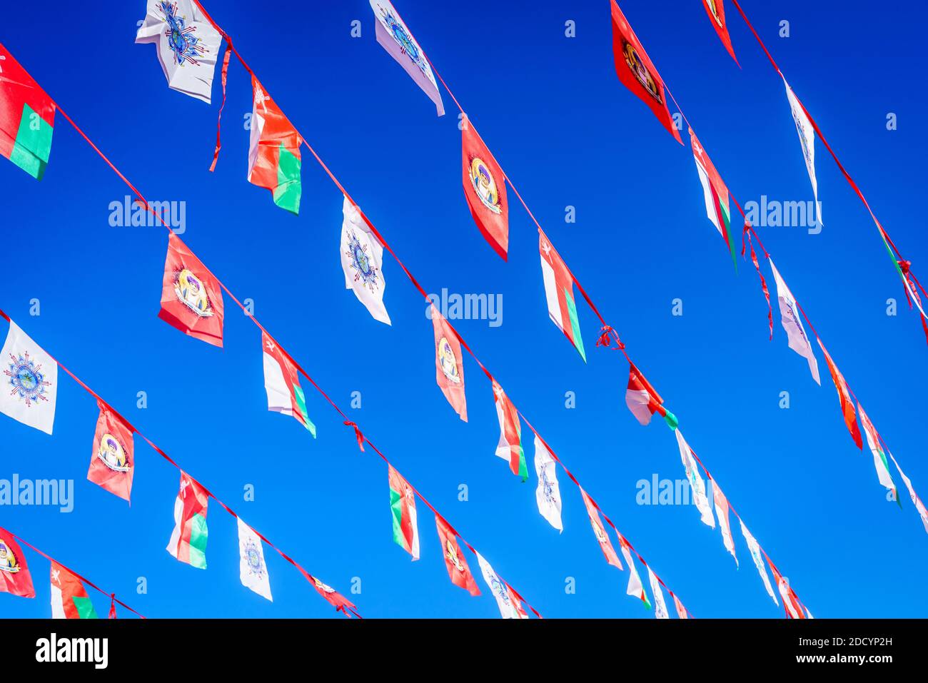 Nizwa, Oman, December 2, 2016: Festive Omani flags against clear blue skies over Friday Market in Nizwa, Oman Stock Photo