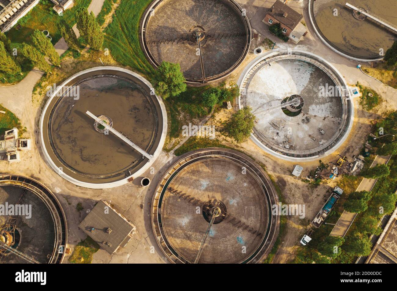Modern sewage treatment plant with round wastewater purification tanks, aerial view from above. Stock Photo