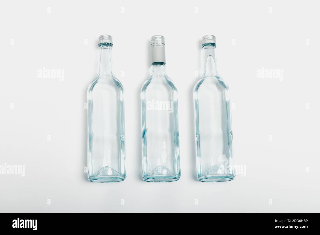 Three clear glass bottle recycled on a white background Stock Photo - Alamy