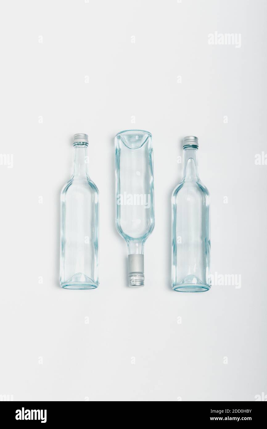 Three clear glass bottle recycled on a white background Stock Photo - Alamy