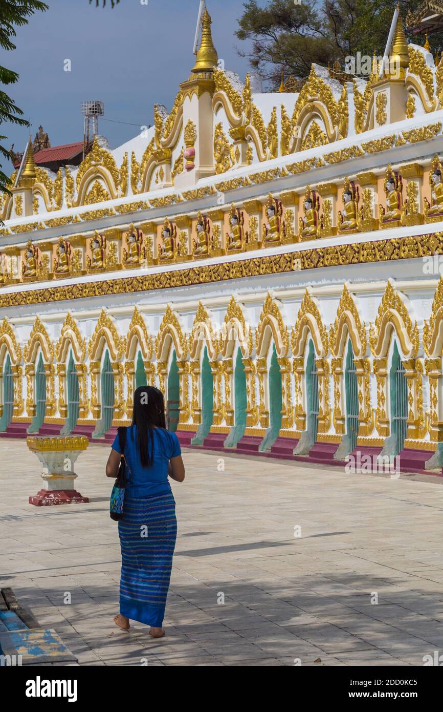 Woman visiting Umin Thounzeh on Sagaing Hill, near Mandalay, Myanmar (Burma), Asia in February Stock Photo