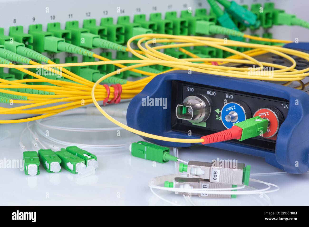 Optical Power Meter and Network of Fiber Patch Cord with Distribustion Frame Closeup Stock Photo