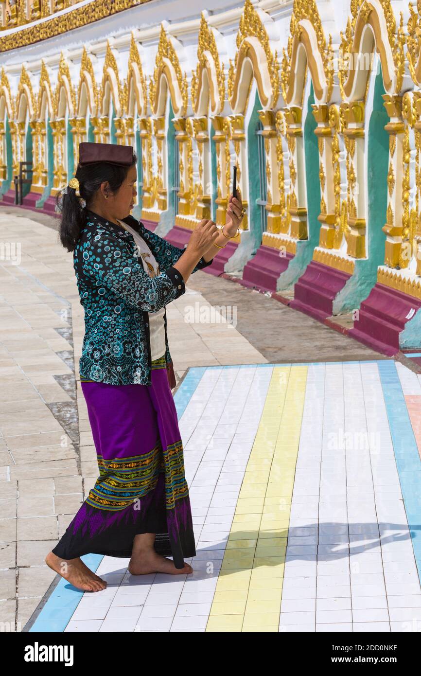 Woman taking photo photograph at Umin Thounzeh on Sagaing Hill, near Mandalay, Myanmar (Burma), Asia in February Stock Photo