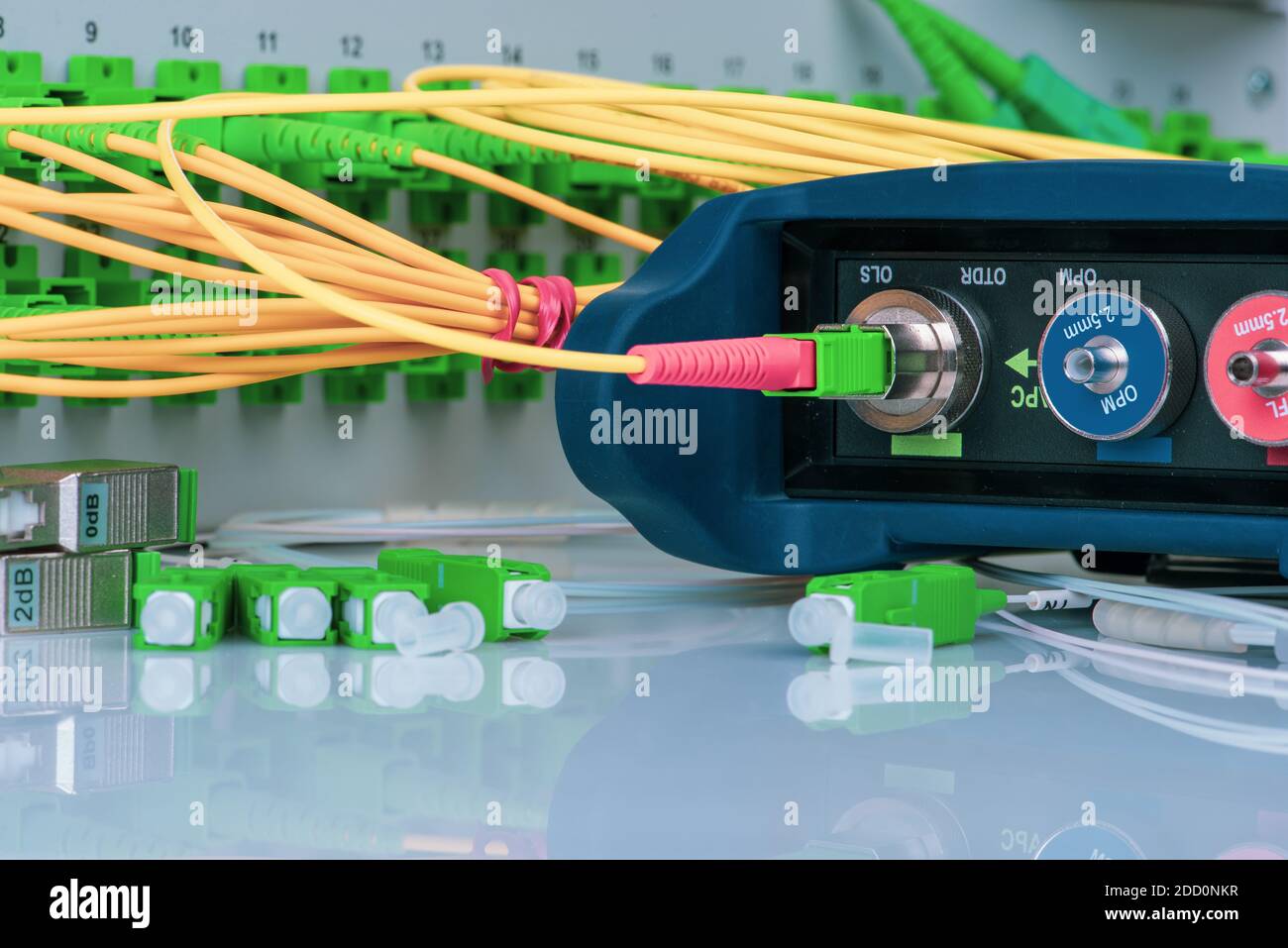 Optical Power Meter and Network of Fiber Patch Cord with Distribustion Frame Closeup Stock Photo