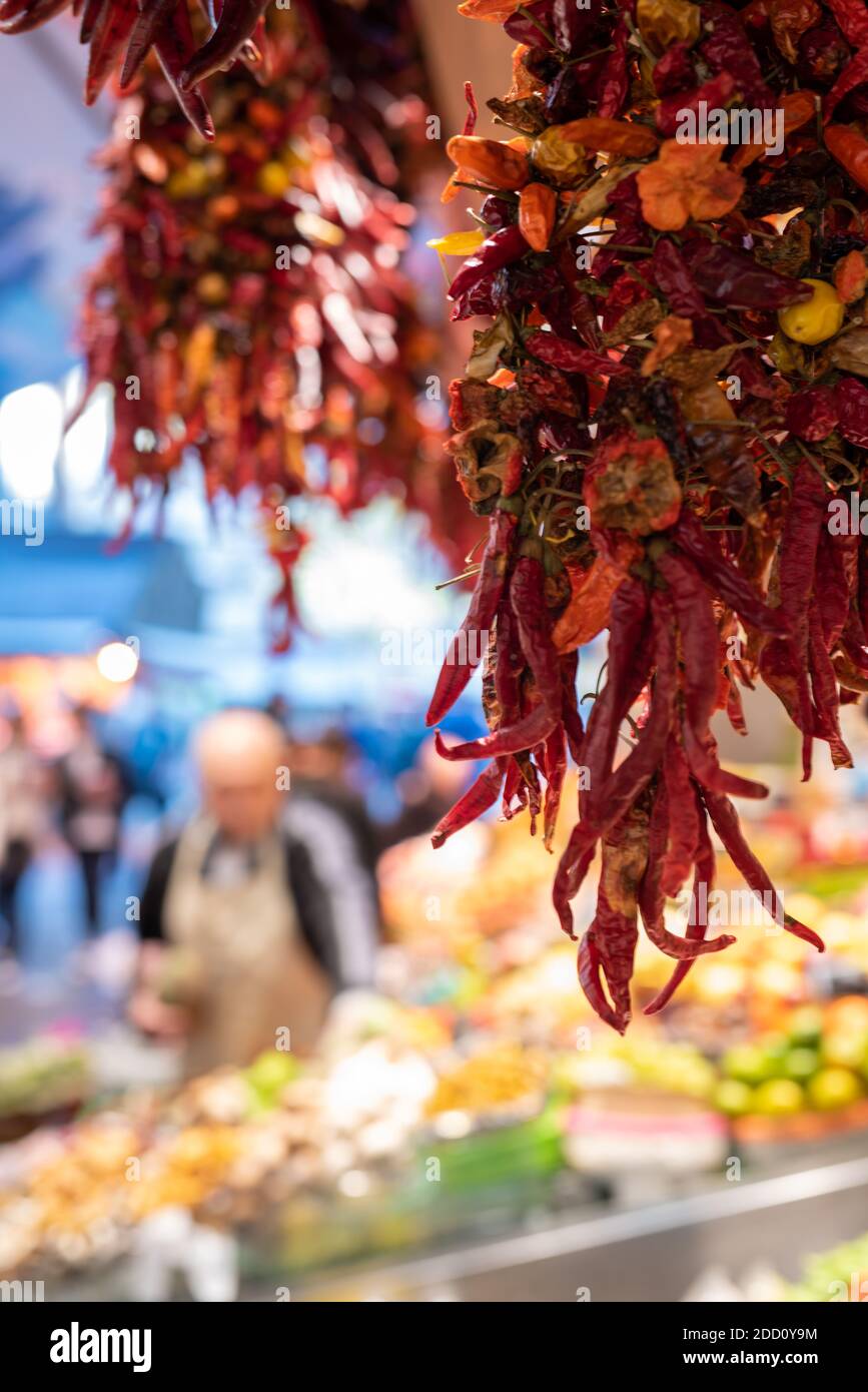 Red Chili Peppers Hanging At Street Food Market Stock Photo