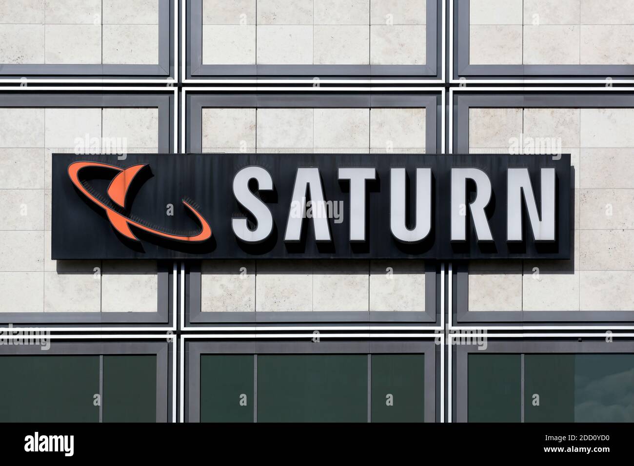 Berlin, Germany - July 12, 2020: Saturn store logo on a wall. Saturn is a German chain of electronics stores in Germany and Luxembourg Stock Photo