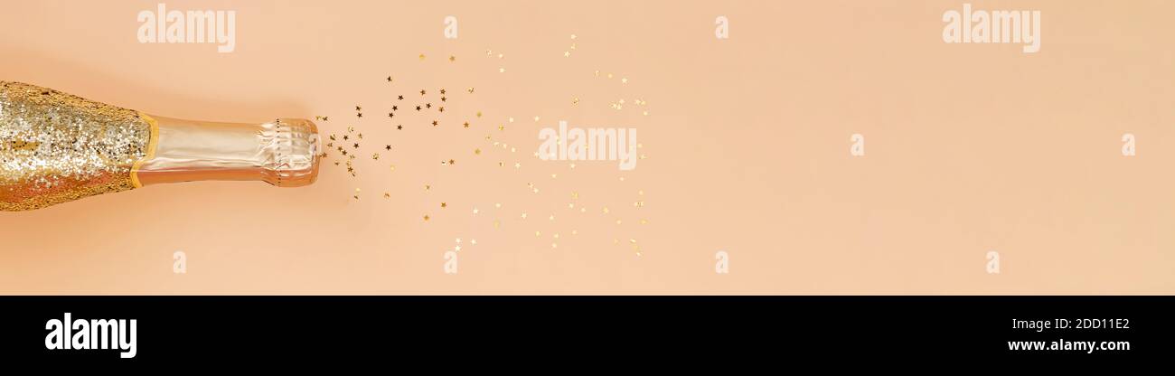 Gold glittering bottle of champagne and star shaped confetti Stock ...