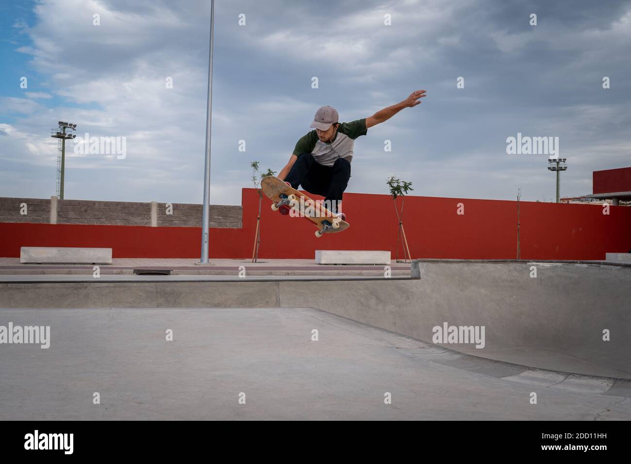 young man does a trick called melon grab in a skate park Stock Photo