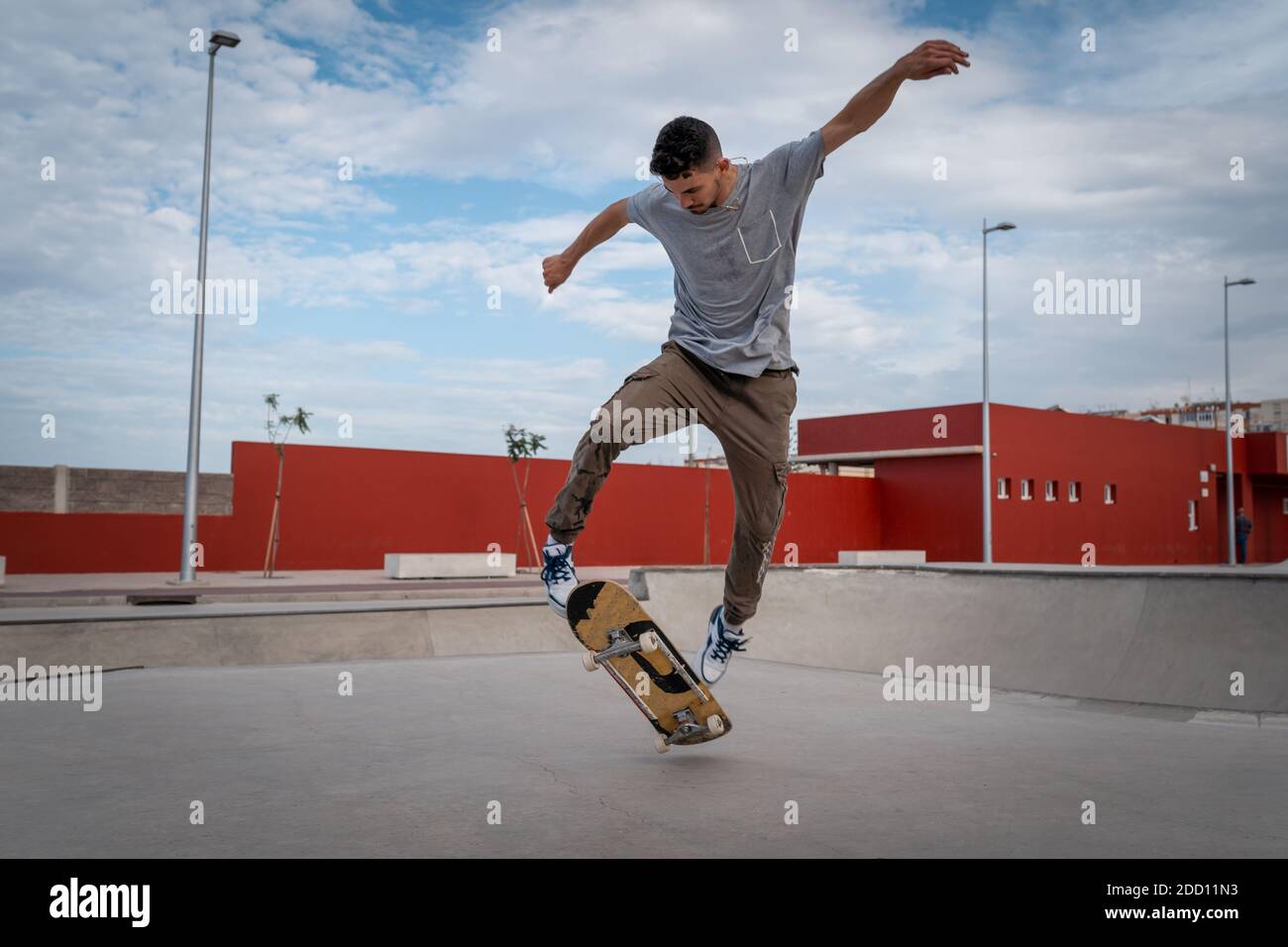 young man does a trick called varial flip in a skate park Stock Photo -  Alamy