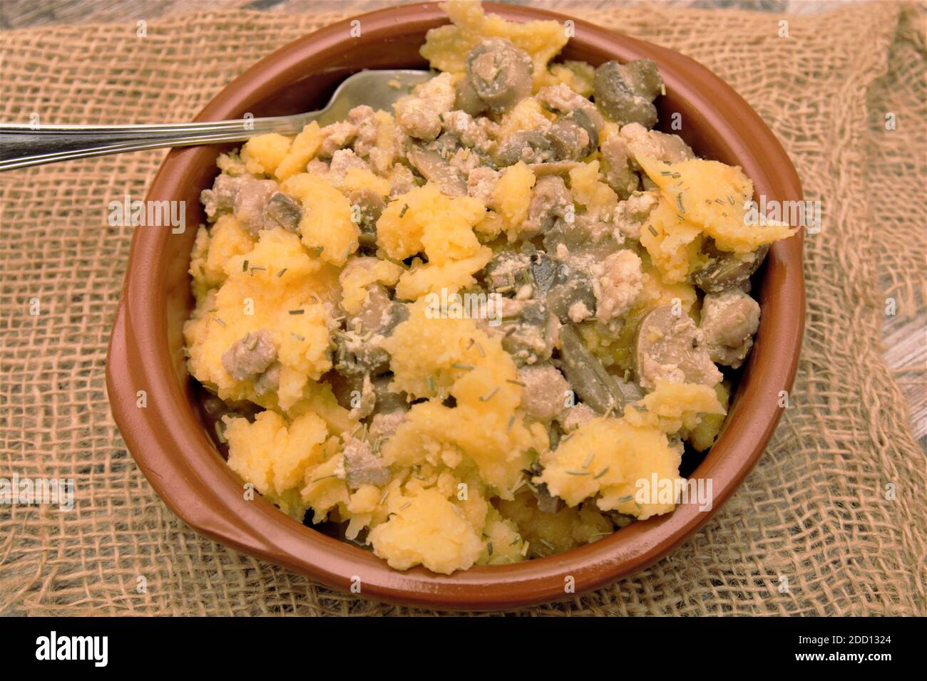 polenta traditional italian dish with pork sausage and mushrooms Stock