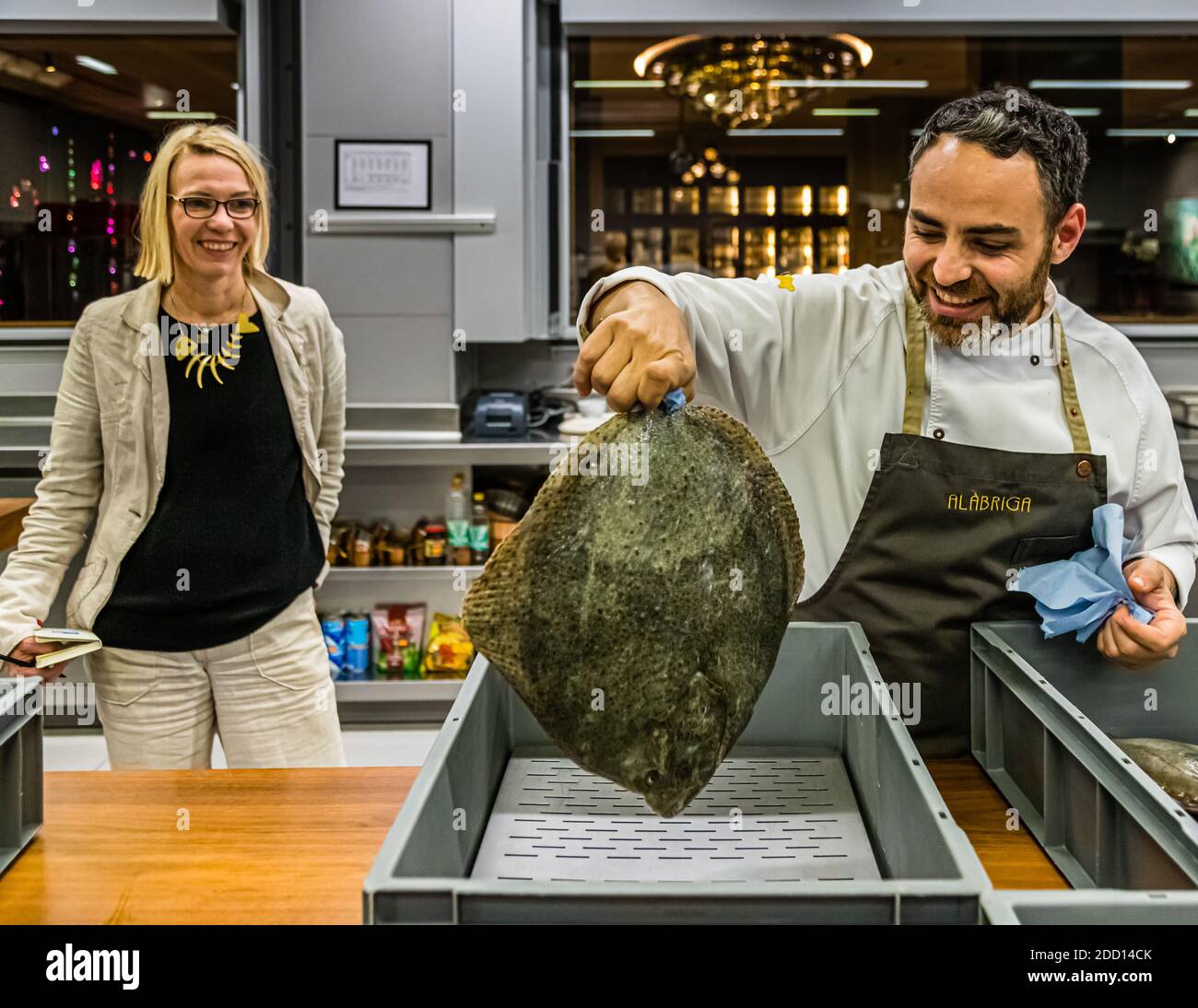 Abraham Artigas holds up a turbot, that he bought at the fish auction in neighboring Palamós. Sant Feliu de Guíxols, Spain Stock Photo