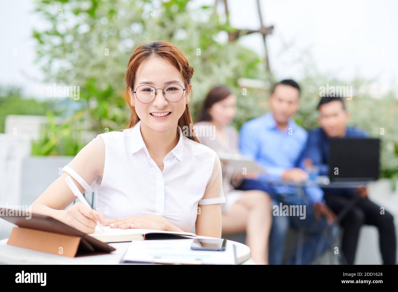 University student at cafe table Stock Photo