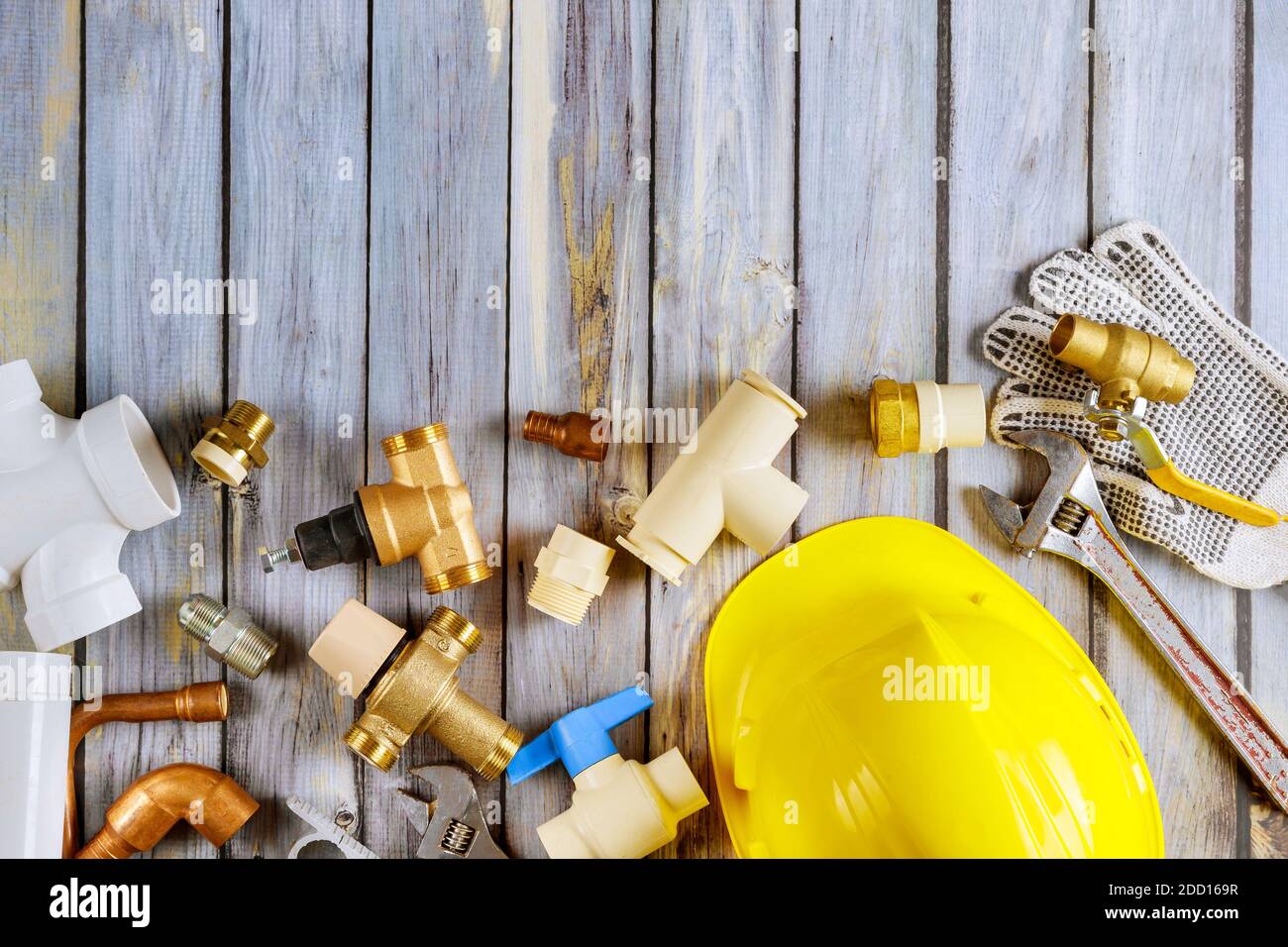 Plumbing tools repair bathroom fixtures fittings are of different construction on wooden worktable. Stock Photo