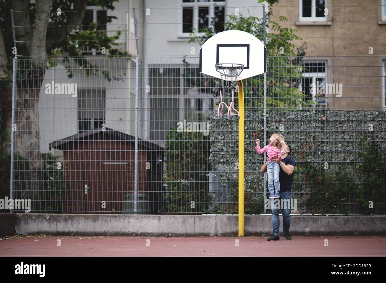 Dad and his disabled daughter play basketball. Stock Photo