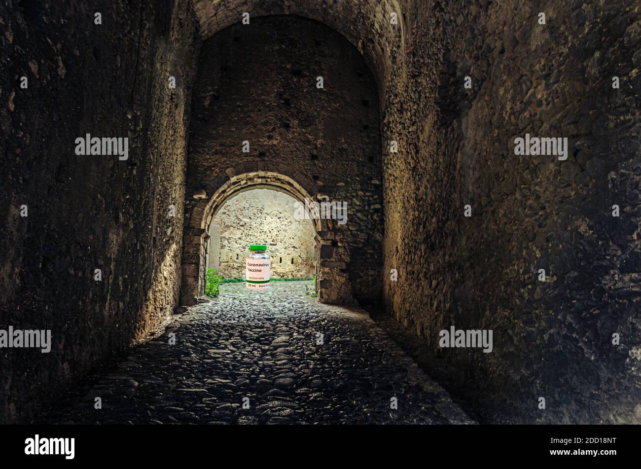 dark tunnel and at the end the light with the covid-19 vaccine. Stock Photo