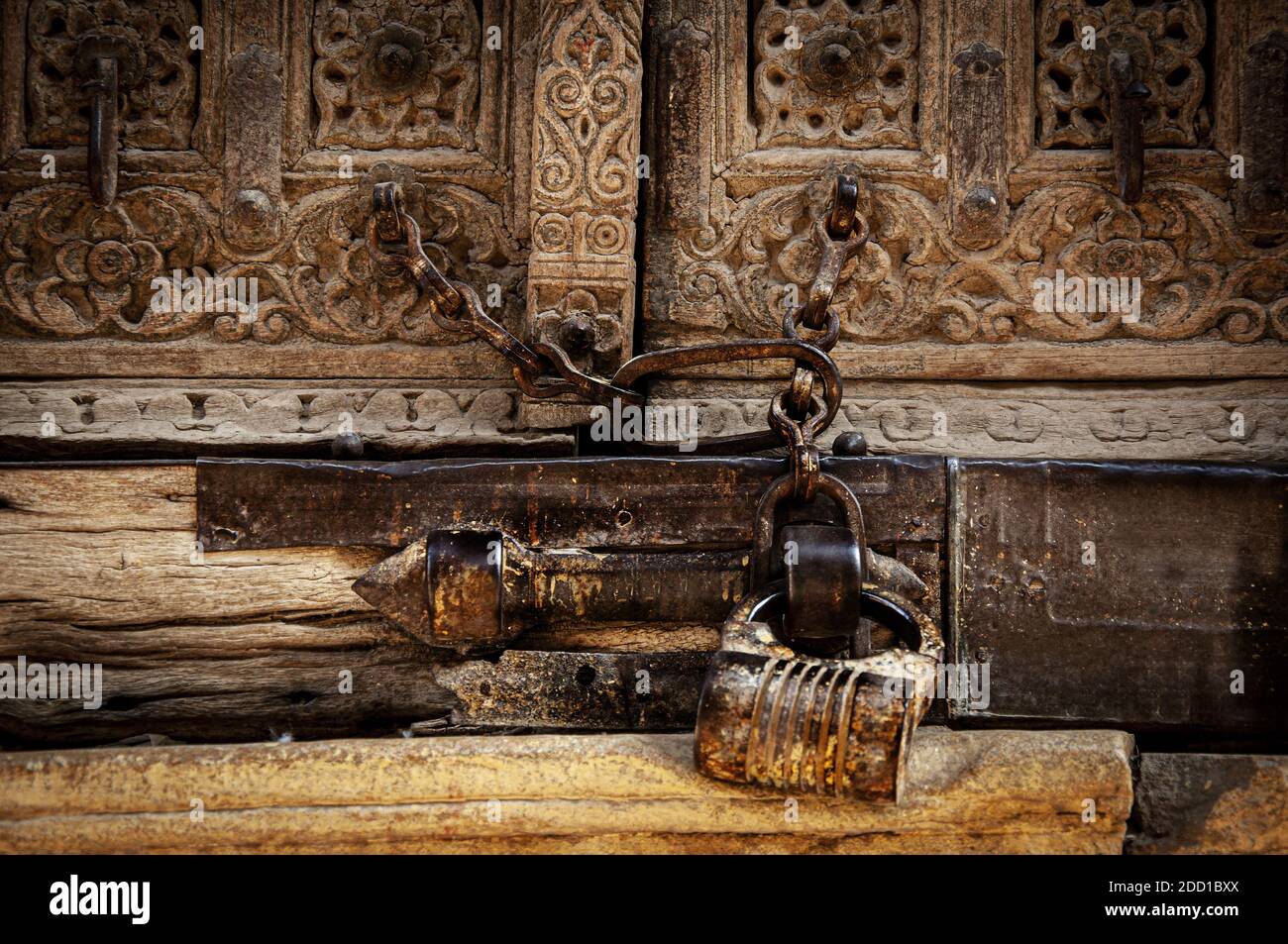 An old wooden carved door with a rusted lock Stock Photo - Alamy