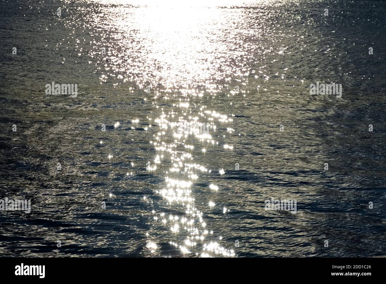 Shimmering sunlight reflections on the surface of the sea by sunset