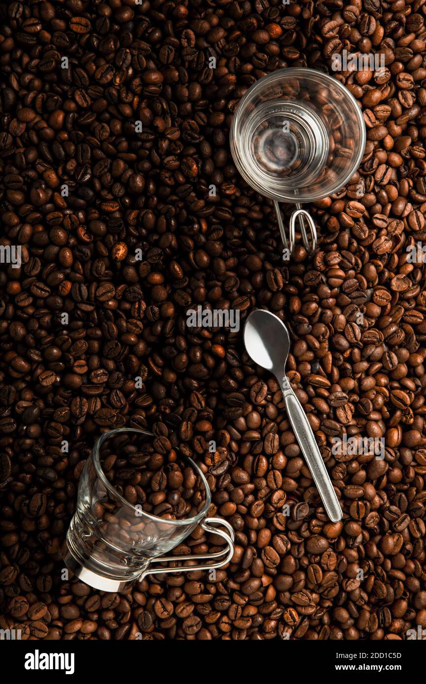 Two Coffee Cups And Spoon On Top Of Coffee Beans Stock Photo