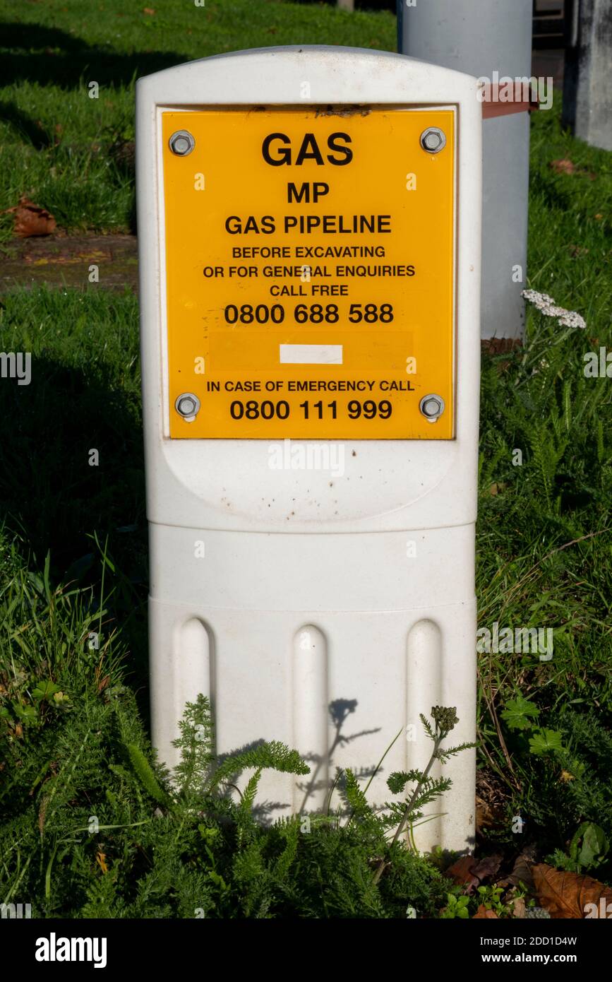 Gas pipeline marker post, warning of gas pipes below ground, on grass verge  Stock Photo - Alamy