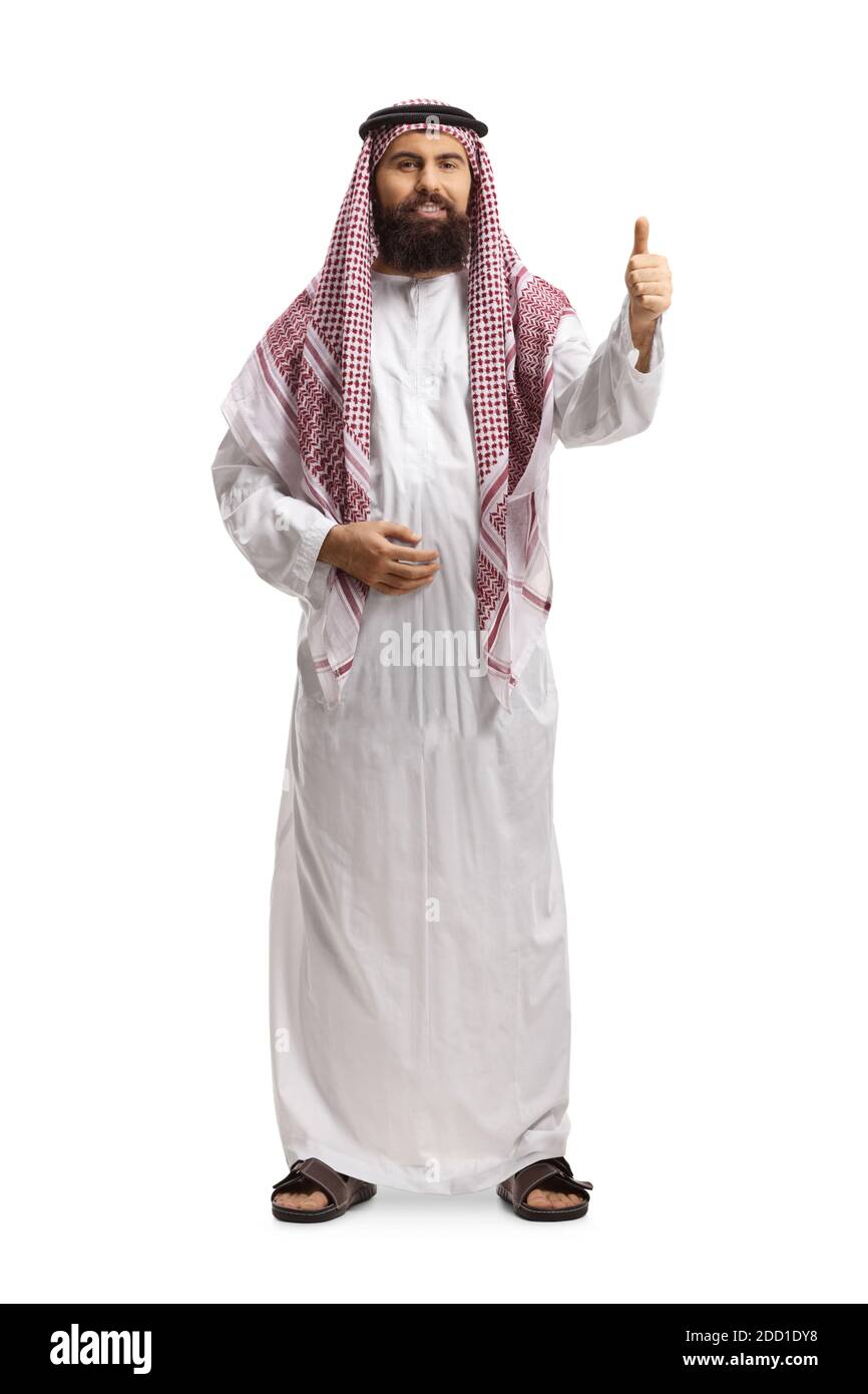 Full length portrait of a saudi arab man wearing a traditional thobe and gesturing a thumb up sign isolated on white background Stock Photo