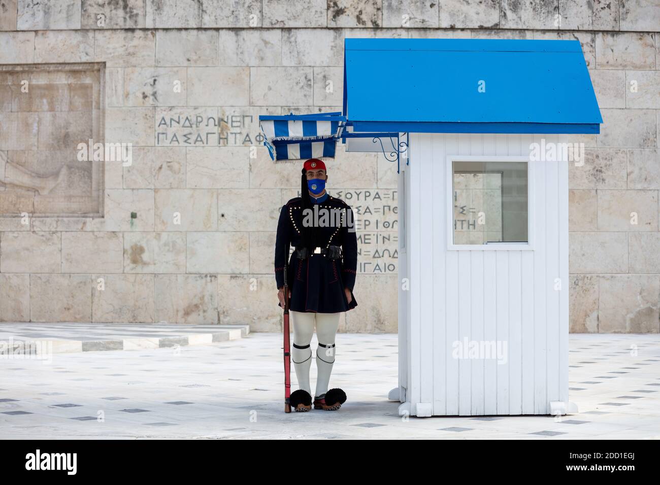 Athens Greece, November 19, 2020. Presidential guard tsolias wearing a COVID 19 protective face mask, standing infront of Greek Parliament building. T Stock Photo