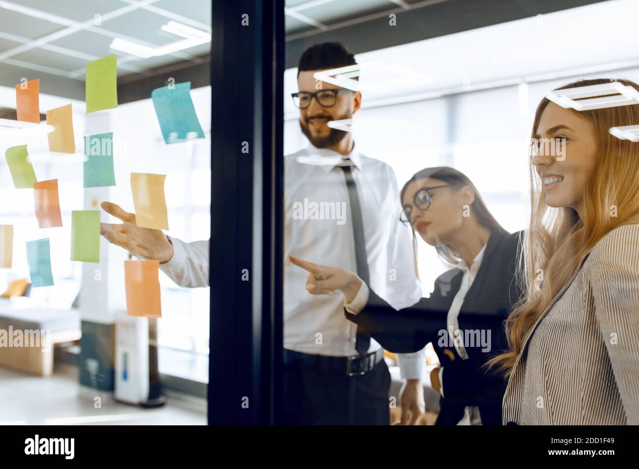 Business colleagues brainstorm with sticky notes at work Stock Photo ...