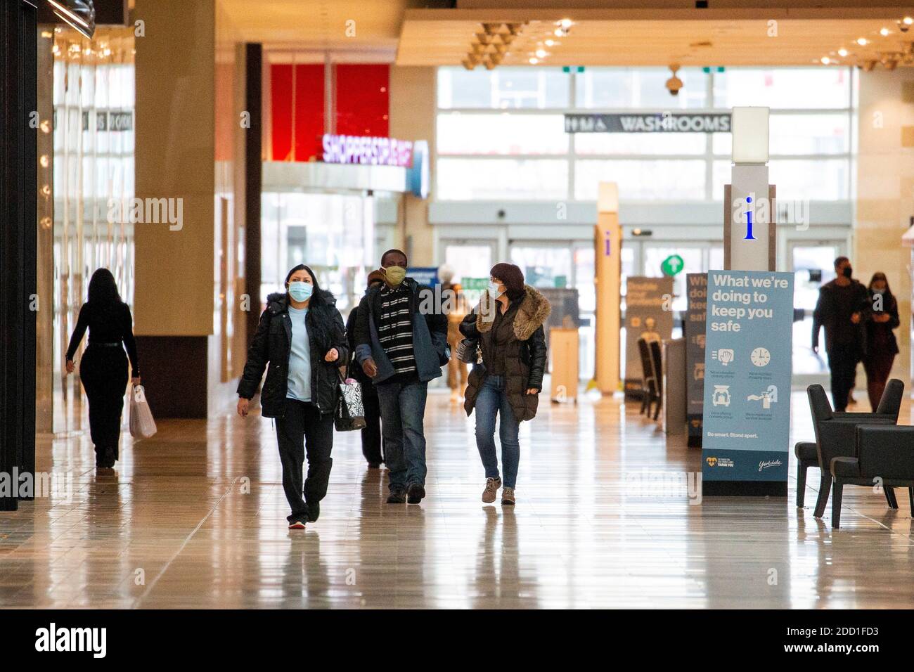 People walks inside Yorkdale Shopping Centre as the city enters the first day of a renewed coronavirus lockdown due to a spike in cases in Toronto, Ontario, Canada November 23, 2020.  REUTERS/Carlos Osorio Stock Photo