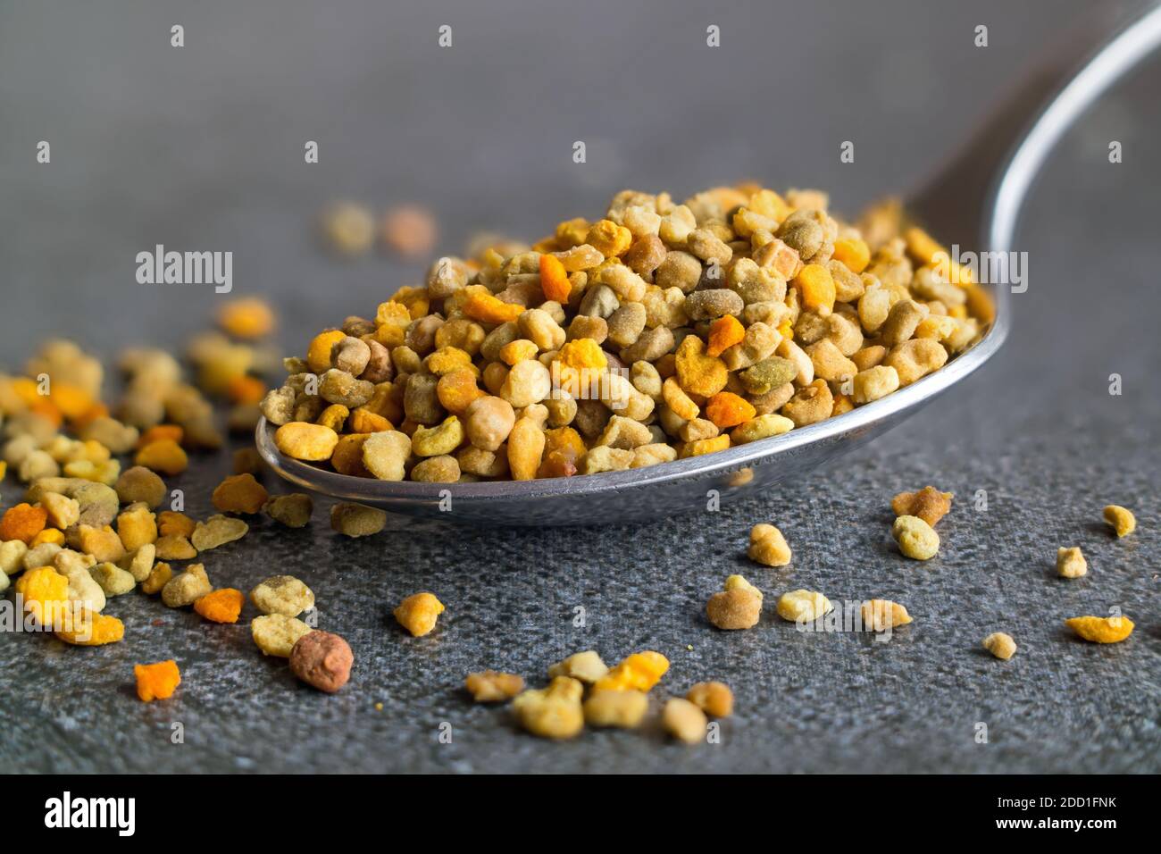 Spoon with healthy bee pollen. Stock Photo