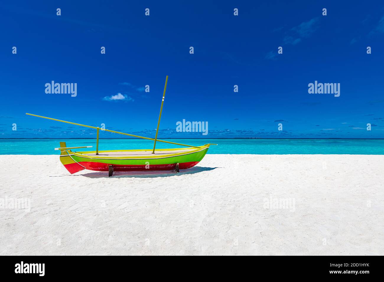 Tropical beach scene with decoration Dhoni boat. Idyllic summer scenery, Maldives islands view, white sand, blue sea and sky with endless horizon. Stock Photo