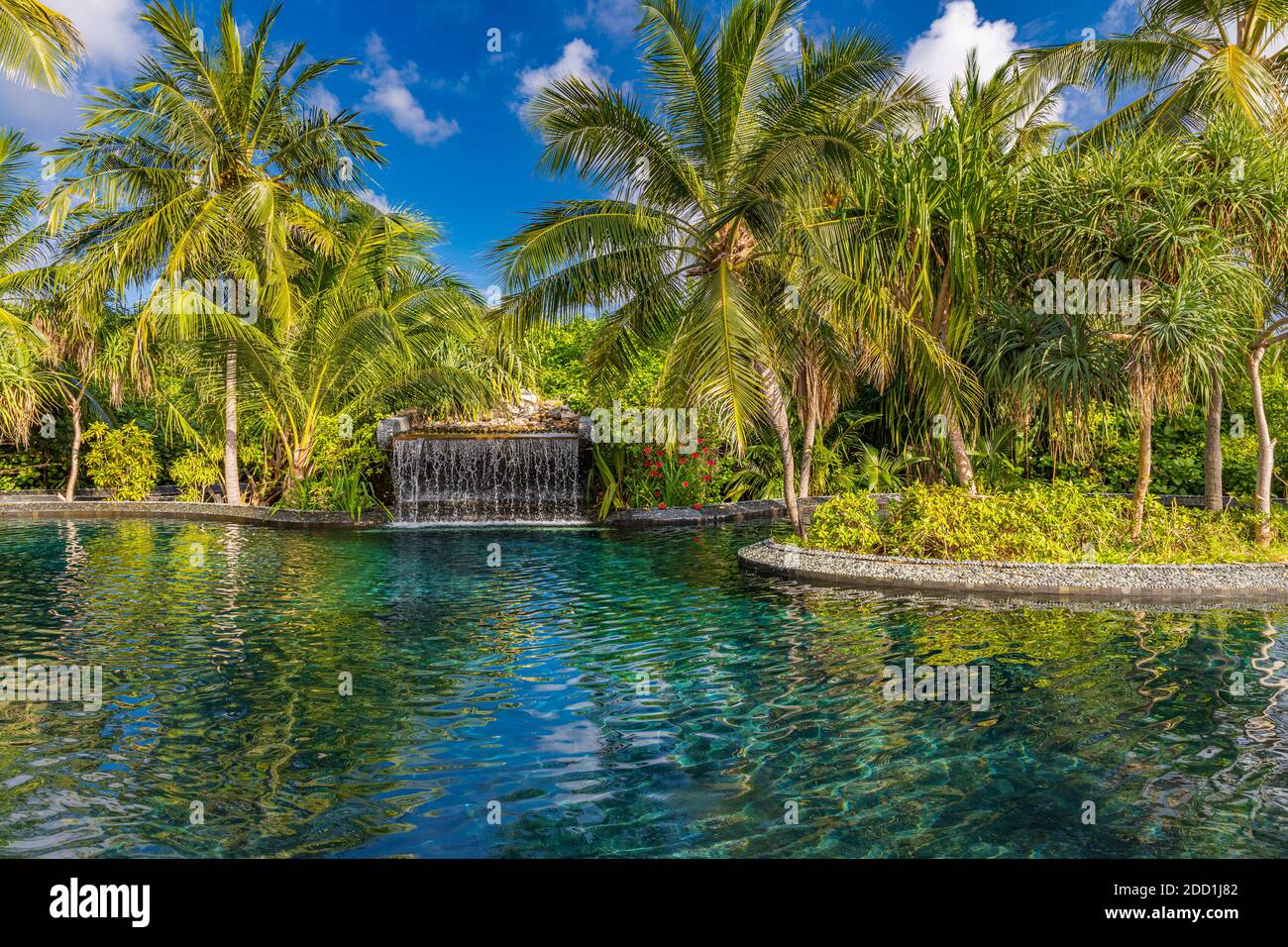 Beautiful luxury hotel pool resort, waterfall with coconut palm trees. Amazing tropical spa, relaxation swimming poolside summer mood vacation holiday Stock Photo