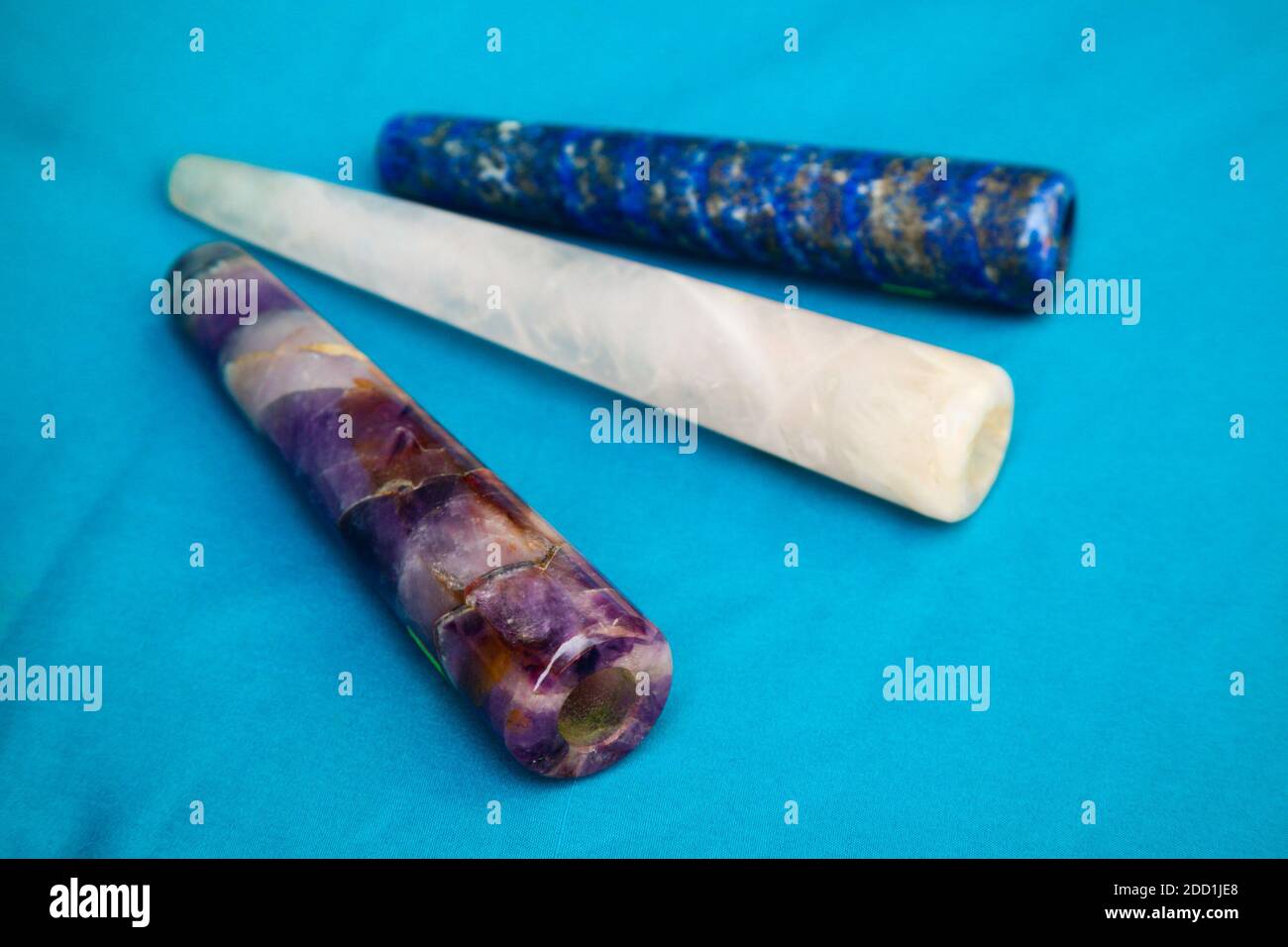 Clay chillum for marijuana smoking on a blue fabric background Stock Photo