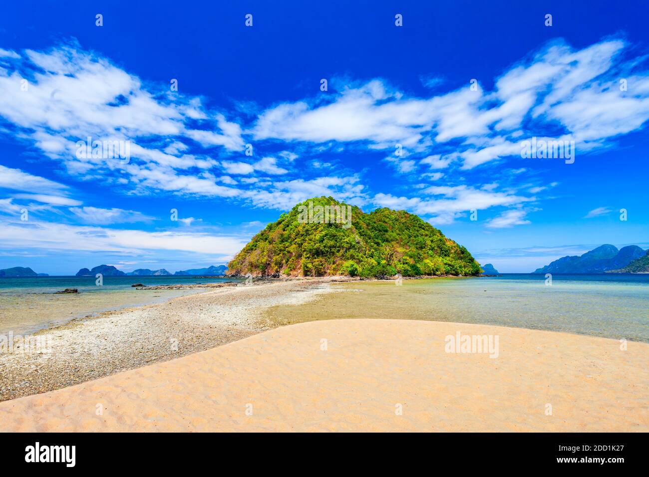 Beach with white sand, coconut palms and turquoise water in El Nido province, Palawan island in