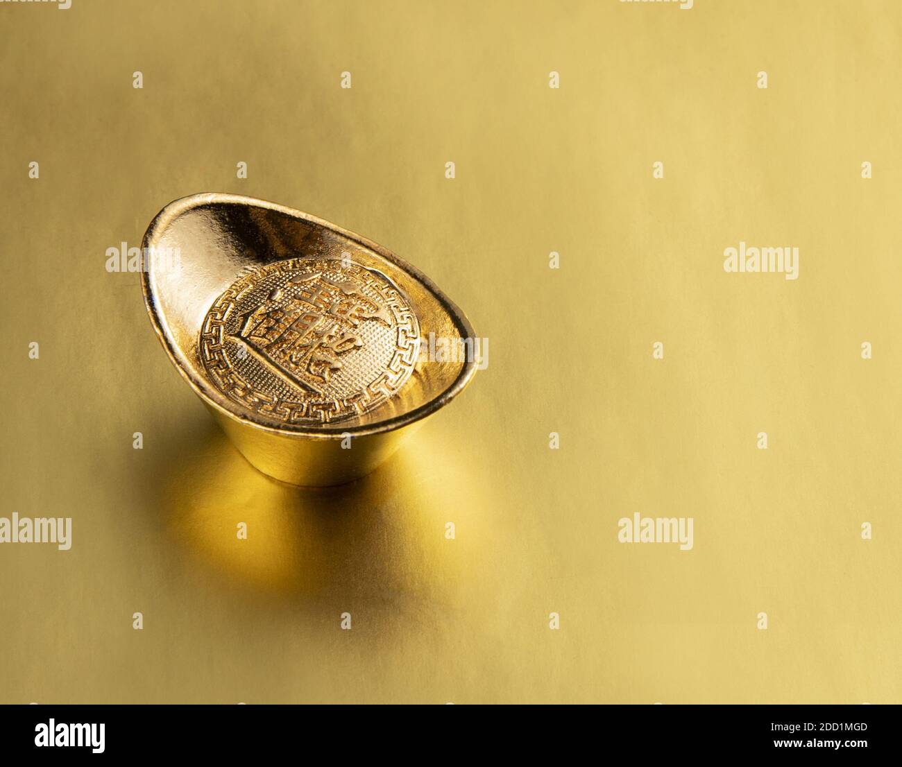 A gold ingot isolated on golden background Stock Photo - Alamy