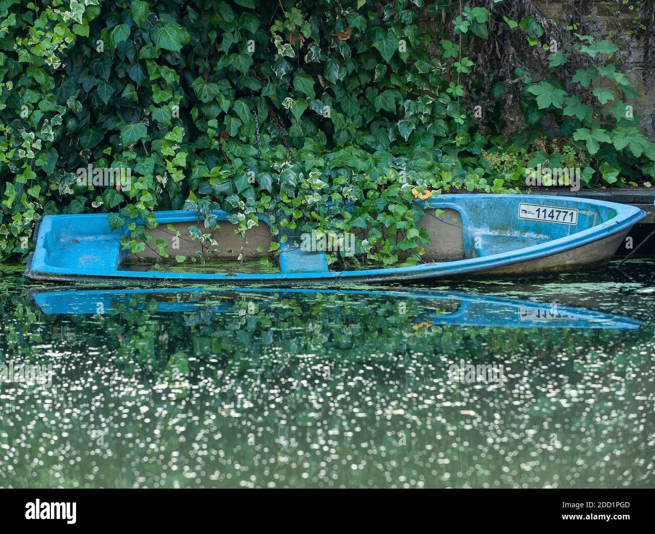 Blue canal boat partially submerged in Regents Canal in London, UK. Stock Photo